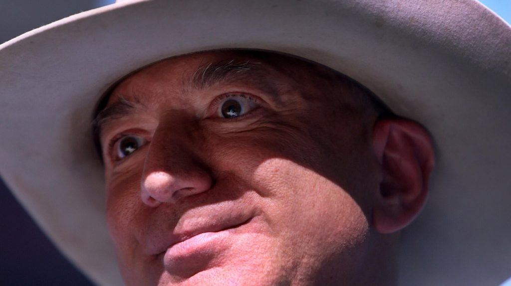 Jeff Bezos in a cowboy hat, staring intently into the camera.