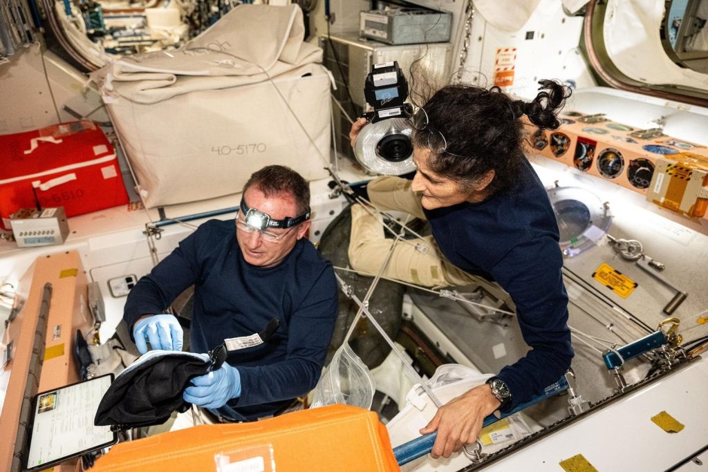 NASA astronauts Butch Wilmore and Suni Williams, Boeing's Crew Flight Test Commander and Pilot respectively, inspect safety hardware aboard the International Space Station.